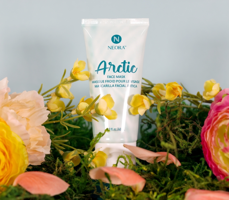 Neora's Arctic Gel Face Mask sitting in a bed of spring flowers.